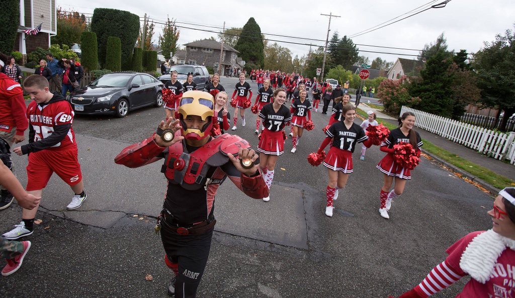 English teacher Tim Fraser-Bumatay wears an Iron Man costume as he and Snohomish High School students walk in the annual Serpentine Parade on Friday, a tradition for generations of students. (Andy Bronson / The Herald)