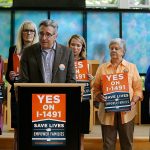 Daniel Weiner, center, Senior Rabbi at Temple De Hirsch Sinai in Bellevue, speaks at Sept. 21 news conference in Bellevue promoting Initiative 1491, which will be on the ballot in the November elections. If passed by voters, the initiative would allow law enforcement or others to obtain court orders to temporarily take guns from people considered a danger to themselves or others. Weiner is a founding member of the Washington Alliance for Gun Responsibility. (AP Photo/Ted S. Warren)