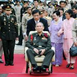 Thailand&rsquo;s King Bhumibol Adulyadej (center) is pushed in a wheelchair as he arrives at a rice field in Ayutthaya province of central Thailand in 2012. Queen Sirikit, in purple, is walking at rear with Princess Sirindhorn. Thailand&rsquo;s Royal Palace said on ThursdayBhumibol, the world&rsquo;s longest-reigning monarch, has died at age 88. (AP Photo/File)