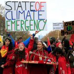 In this Dec. 12, 2015, photo, climate activists demonstrate during COP21, the United Nations Climate Change Conference, in Paris, France. (AP Photo/Thibault Camus, File)