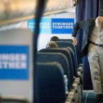 Hillary Clinton&rsquo;s campaign manager John Podesta speaks with senior aide Huma Abedin aboard Clinton&rsquo;s campaign plane while traveling to Miami on Tuesday for a rally. (AP Photo/Andrew Harnik)