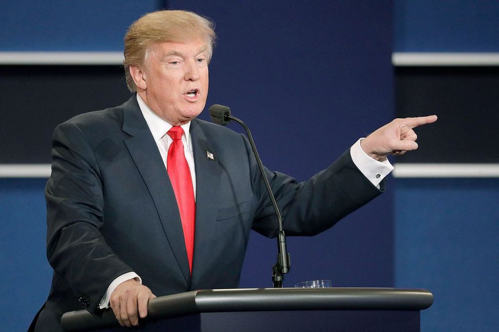 Republican presidential nominee Donald Trump points toward Democratic presidential nominee Hillary Clinton as he answers a question during the third presidential debate at UNLV in Las Vegas on Wednesday. (AP Photo/John Locher)