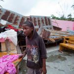 A boy stands inside a church after it was damaged by Hurricane Matthew in Saint-Louis, Haiti, on Wednesday. Rescue workers in Haiti struggled to reach cutoff towns and learn the full extent of the death and destruction caused by Hurricane Matthew as the storm began battering the Bahamas on Wednesday and triggered large-scale evacuations along the U.S. East Coast. ( AP Photo/Dieu Nalio Chery)