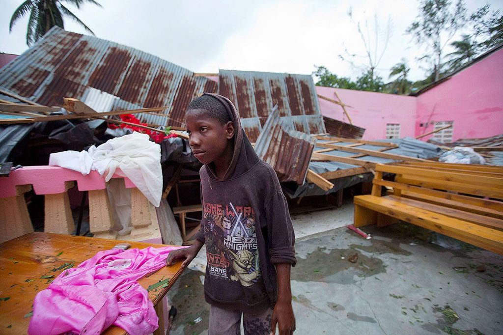 A boy stands inside a church after it was damaged by Hurricane Matthew in Saint-Louis, Haiti, on Wednesday. Rescue workers in Haiti struggled to reach cutoff towns and learn the full extent of the death and destruction caused by Hurricane Matthew as the storm began battering the Bahamas on Wednesday and triggered large-scale evacuations along the U.S. East Coast. ( AP Photo/Dieu Nalio Chery)