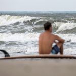 Eric Dunn sits on the beach on Tybee Island, Georgia, on Tuesday, watching larger-than-normal waves roll in as a result of approaching Hurricane Matthew. (Josh Galemore/Savannah Morning News via AP)