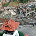 This aerial photo shows fallen tomb stones scattered at a cemetery following an earthquake in Kurayoshi, Tottori prefecture, western Japan, on Friday, Oct. 21. The powerful earthquake with a preliminary magnitude of 6.6 struck western Japan on Friday, toppling shelves and knocking out power to thousands of homes. There was no risk of a tsunami. (Kyodo News via AP)