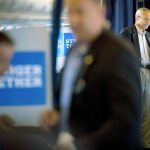 Hillary Clinton&rsquo;s campaign manager, John Podesta (second from right), speaks with senior aide Huma Abedin aboard Clinton&rsquo;s campaign plane while traveling to Miami on Tuesday for a rally. (AP Photo/Andrew Harnik)