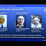 A overhead projector displays the photos of the winners of the Nobel Prize in physics at the Royal Swedish Academy of Sciences in Stockholm, Sweden, on Tuesday. David Thouless, Duncan Haldane and Michael Kosterlitz have won the Nobel physics prize. (Anders Wiklund /TT via AP)