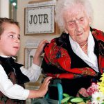 Thomas, 5, looks at Jeanne Calment after he brought her flowers at her retirement home in Arles, France, in 1997. Calment, believed to be the world&rsquo;s oldest person, died at the age of 122 in 1997. (AP Photo/Florian Launette)