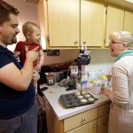 In this Thursday, Oct. 13, 2016, photo, Shavonne Henry, right, greets her 7-month-old son, Jordan, as her husband, Michael Henry, brings him into the kitchen after a nap at their apartment in Vancouver, Wash. Nearly half of all Americans aged 18 to 30 have nothing in retirement savings and no access to a traditional pension, according to a survey. &ldquo;I feel pretty good about our future,&rdquo; says Shavonne Henry. &ldquo;The reason we got to saving at all was I took a finance class in college, and part of the course was: If you want to have the kind of retirement you want to have, you should start saving at 20,&rdquo; she says. &ldquo;I don&rsquo;t think that&rsquo;s talked about enough.&rdquo; (AP Photo/Don Ryan)