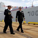 Capt. James Kirk (right), commanding officer of the USS Zumwalt walks past the ship to a news conference in Baltimore on Thursday. (AP Photo/Patrick Semansky)