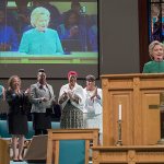 Democratic presidential candidate Hillary Clinton is joined by mothers of black men who died from gun violence, Geneva Reed-Veal, left, mother of Sandra Bland, Lucia McBath, second from left, mother of Jordan Davis, Sybrina Fulton, center, mother of Trayvon Martin, Maria Hamilton, second from right, mother of Dontre Hamilton, and Gwen Carr, mother of Eric Garner as she speaks during Sunday service at Union Baptist church, Sunday, Oct. 23, in Durham, North Carolina. (AP Photo/Mary Altaffer)