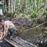A FARC guerilla fighter from the southern bloc washes himself in the base camp. (The Washington Post/Joao Pina)