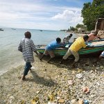 Fishermen move their boats out of the water Sunday before the arrival of Hurricane Matthew in Arcahaie, Haiti. ( AP Photo/Dieu Nalio Chery)