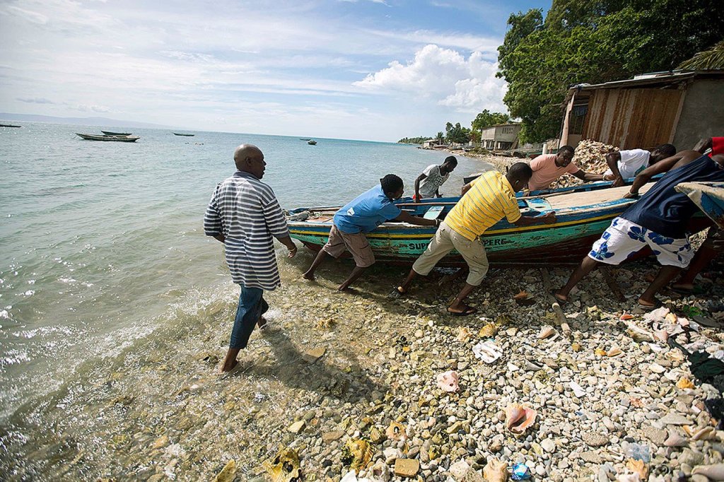 Fishermen move their boats out of the water Sunday before the arrival of Hurricane Matthew in Arcahaie, Haiti. ( AP Photo/Dieu Nalio Chery)