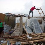 Residents repair their homes destroyed by Hurricane Matthew in Les Cayes, Haiti, on Thursday. (AP Photo/Dieu Nalio Chery)