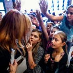 Faces of young Evergreen Middle School students reveal a sense of anticipation as well as concentration on an answer to the question: name one thing you can do at a library besides check out books? The anticipation may have more to do with ice cream bars that assistant principal Carmen Boggs is holding. (Dan Bates / The Herald)