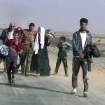 This image made from video by Rudaw News Agency shows a family fleeing Mosul, Iraq on Tuesday, Oct. 18. Residents who have endured more than two years of militant rule describe a city under siege, and say a new sense of terror has set in since Iraq announced the start of a long awaited operation to liberate its second largest city. (Rudaw News Agency via AP)