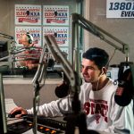 Viewed through sound proof window panes from a third work station, Sean Ryan (foreground) hosts 1380 KRKO while Stitch Mitchell (backround) hosts 1520 KKXA Wednesday morning. (Dan Bates / The Herald)