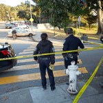 San Francisco Police stand at the site of a shooting outside the June Jordan School for Equity and City Arts and Technology High School, which share a campus, in San Francisco on Tuesday, Oct. 18. Several teenage students were shot in the shared parking lot of the two San Francisco high schools Tuesday. One of the students is in critical condition, authorities said. (Scott Strazzante/San Francisco Chronicle via AP)