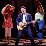 The character Jackson makes his guitar sing while the Cupp sisters dance in the Village Theatre show at Everett Performing Arts Center. (Village Theatre photo)
