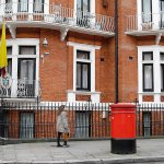 A woman walks past the Ecuadorian Embassy in London, Tuesday, Oct. 18, 2016. (AP Photo/Alastair Grant)