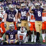 Washington&rsquo;s Myles Gaskin (seated) along with members of the offense await the call from the line judge for the touchdown Saturday afternoon at Husky Stadium in Seattle. (Kevin Clark / The Herald)