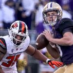 Washington&rsquo;s Jake Browning winds up to pass with Oregon State&rsquo;s Caleb Saulo closing Saturday afternoon at Husky Stadium in Seattle. (Kevin Clark / The Herald)