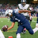 Meadowdale&rsquo;s Jashon Butler reaches across the goal line for a touchdown on a 24-yard interception return in the second quarter with Lynnwood&rsquo;s Harris Cutuk closing in during a game Friday night at Edmonds Stadium. The Mavericks beat the Royals 55-28 for their fifth consecutive win. (Kevin Clark / The Herald)