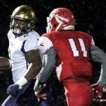 Oak Harbor&rsquo;s Princeton Lollar looks back at Marysville Pilchuck&rsquo;s Jordan Harris while running for a touchdown Thursday at Quil Ceda Stadium in Marysville. (Kevin Clark / The Herald)