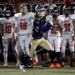 Lake Stevens&rsquo; Hunter Eckstrom races for the end zone with members of Monroe looking on during a game Friday at Lake Stevens High School. (Kevin Clark / The Herald)
