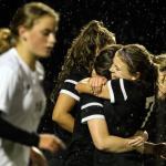 Kamiak&rsquo;s Sarah Nehring, right, hugs teammate Jenny Wrobel after Wrobel&rsquo;s goal in the closing minutes of the match with Lake Stevens&rsquo; Peyton Moenoa, left, makes her way back to the line Thursday night at Lake Stevens High School on October 13, 2016.(Kevin Clark / The Herald)