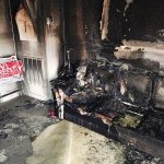 A burned couch is shown next to warped campaign signs at the Orange County Republican Headquarters in Hillsborough, North Carolina, on Sunday. Someone threw flammable liquid inside a bottle through a window overnight and someone spray-painted an anti-GOP slogan referring to &ldquo;Nazi Republicans&rdquo; on a nearby wall, authorities said Sunday. State GOP director Dallas Woodhouse said no one was injured. (AP Photo/Jonathan Drew)
