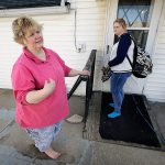 In this April 14, 2016, photo, Denise Kirchner and her daughter, Madison, right, talk about an accidental shooting a few days before Thanksgiving 2015, in their home in Toledo, Iowa. (AP Photo/Charlie Neibergall)