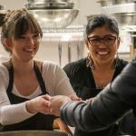 Miranda Gable hands over a bowl of soup with fellow server Joan Butts at Lake Stevens Calvary Chapel on Saturday. (Kevin Clark / The Herald)