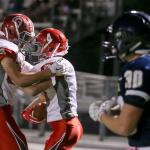 Stanwood&rsquo;s Gavin Schwietzer congratulates teammate Trygve DeBoer on his touchdown reception with Arlington&rsquo;s Devon Nutter (far right) walking away during the annual Stilly Cup football game Friday night in Arlington. (Kevin Clark / The Herald)