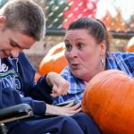 Deanna Locke (right) shows off her pumpkin selection to her son, Ian Locke, on Saturday morning at Fred Meyer in Monroe. (Kevin Clark / The Herald)