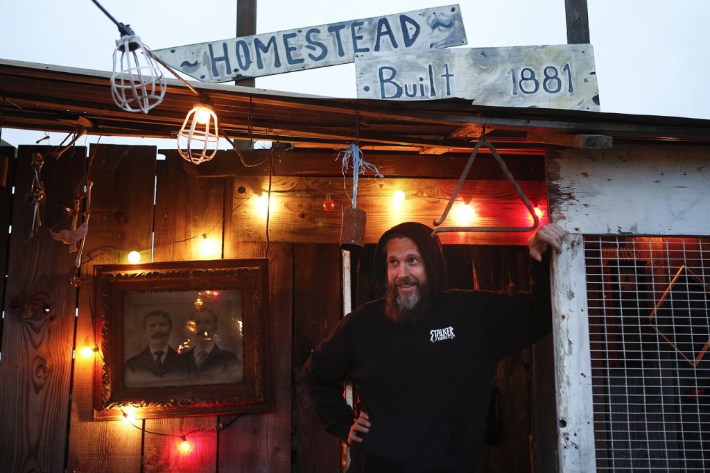 Stalker Farms haunt director Dan Orme-Doutre stands at the entrance to his &ldquo;The Harvest&rdquo; haunt on Friday evening before it opened to the public. When designing the haunts at Stalker Farms, Orme-Doutre focuses on building an experience that scares guests but also provides them with a story line to follow. (Ian Terry / The Herald)