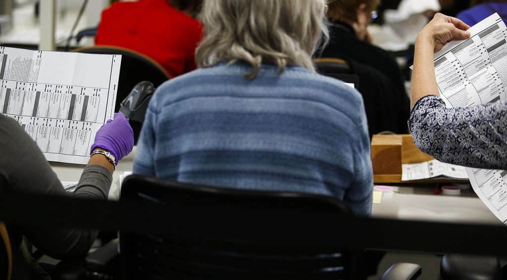 Workers examine ballots at the Snohomish County ballot return center in Mukilteo on Thursday, Oct. 27. (Ian Terry / The Herald)