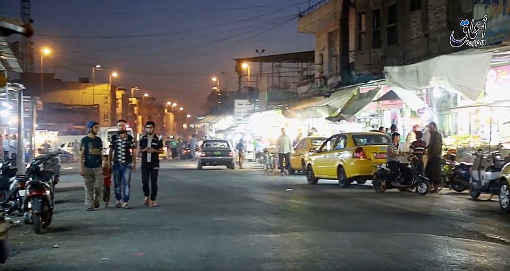This image made from video posted online on Monday, Oct. 17, by Amaq News Agency of the Islamic State militant group shows a street scene in Mosul, Iraq. (militant video, Amaq News Agency via AP)