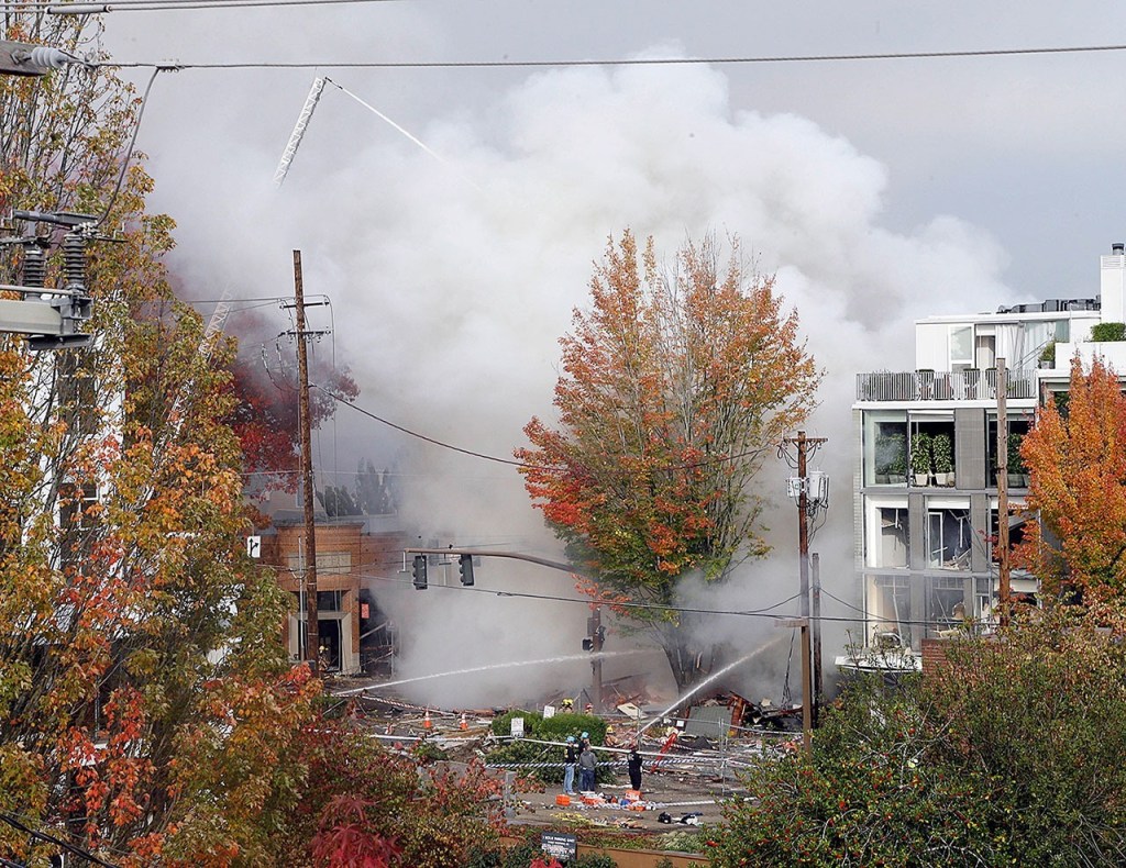 Smoke rises as firefighters battle a blaze after a gas explosion in Portland, Orgon, on Wednesday. (AP Photo/Don Ryan)