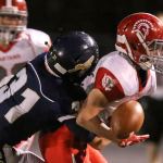 Arlington&rsquo;s Payton Bastien breaks up a pass intended for Stanwood&rsquo;s Trygve DeBoer during the annual Stilly Cup football game Friday night in Arlington. (Kevin Clark / The Herald)