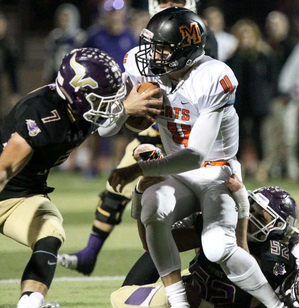 Lake Stevens&rsquo; Austin Calvin (left) and Zack Kylany work to sack Monroe&rsquo;s Zach Zimmerman during a game Friday at Lake Stevens High School. (Kevin Clark / The Herald)