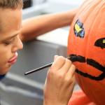 Kavan Dunbar, 9, paints his pumpkins Saturday morning at Fred Meyer in Monroe. (Kevin Clark / The Herald)