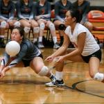 Monroe&rsquo;s Alexa Thompson digs a ball with teammate Mina Duong looking on during the Bearcats&rsquo; five-set loss to Lake Stevens on Thursday night in Monroe. (Kevin Clark / The Herald)