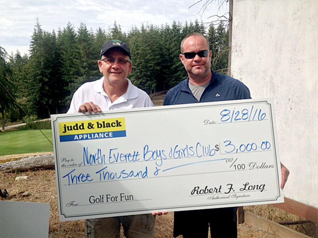 Mike McGinnis, unit director at the North Everett Boys & Girls Club (left) accepts a $3,000 check from Judd & Black&rsquo;s Cory Long at the conclusion of the company&rsquo;s annual charity golf tournament at Battle Creek Golf Course. (Contributed photo)