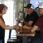 &mdash; Bartender Peri-Lyn Johnson (left) chats with Ryan Gagnon and Dan Misich . Gagnon and Misich custom built and installed all of the shelves, tables and the bar at the newly opened bottleshop. (Ian Terry / The Herald)