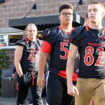 Members of the football team leave a press conference at Archbishop Murphy High School in Everett last week. (Kevin Clark / The Herald)