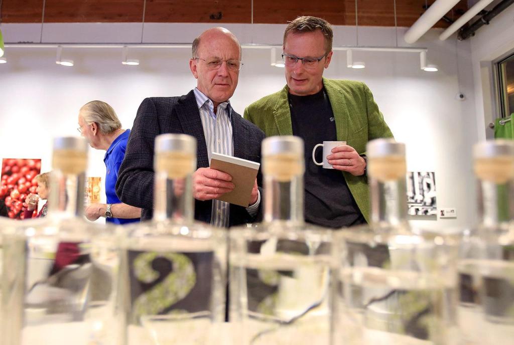 Benny Teal, left, talks with Bryan Karrick during the Giniology class at Scratch Distillery Saturday night in Edmonds on April 17, 2016. (Kevin Clark / The Herald)