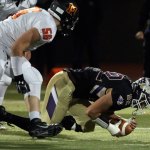 Lake Stevens&rsquo; Zack Kylany recovers a fumble with Monroe&rsquo;s Peyton McMahon trailing during a game Friday at Lake Stevens High School. (Kevin Clark / The Herald)